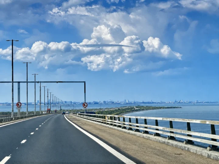 Blick über die Fahrbahn der Öresundbrücke Richtung Dänemark, am Horizont die Skyline von Kopenhagen